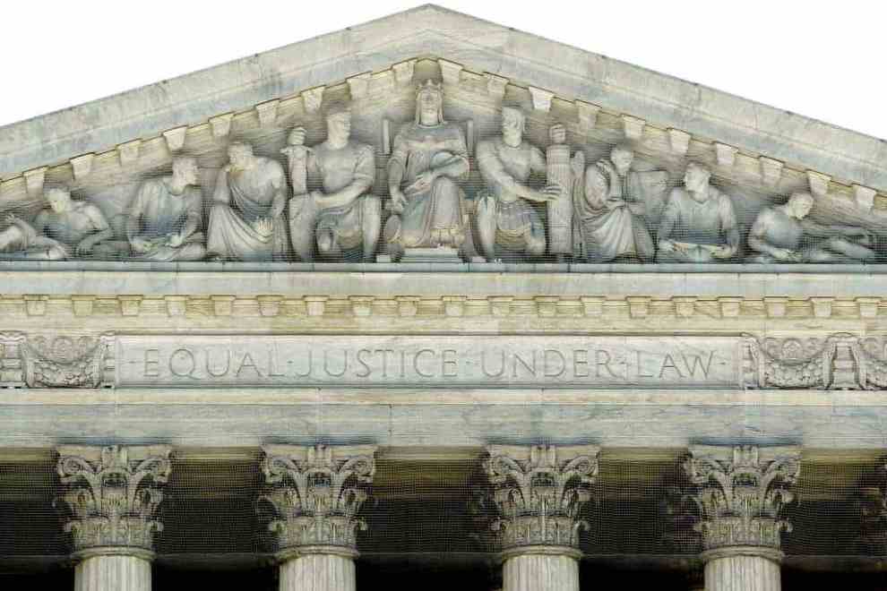 "Equal Justice Under Law" is carved into the facade of the United States Supreme Court building June 29, 2009 in Washington, DC. The court handed down a major civil rights decision toady when it ruled that white firefighters in New Haven, Connecticut, suffered unfair discrimination because of their race when the city scrapped the results of a promotional exam in Ricci v. DeStefano. (Photo by Chip Somodevilla/Getty Images)