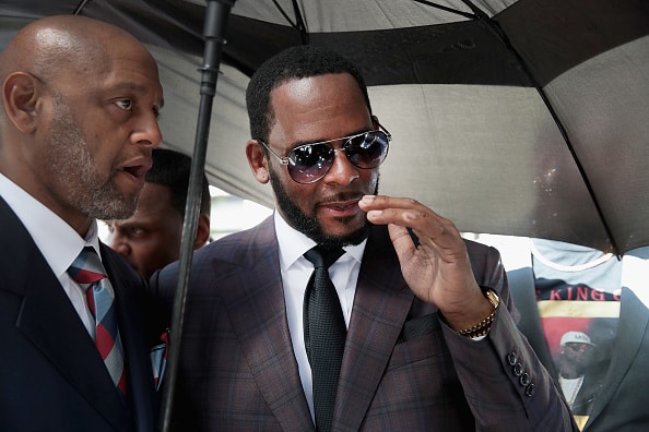 singer R. Kelly (R) leaves the Leighton Criminal Courts Building following a hearing on June 26, 2019 in Chicago, Illinois. Prosecutors turned over to Kelly's defense team a DVD that alleges to show Kelly having sex with an underage girl in the 1990s. Kelly has been charged with multiple sex crimes involving four women, three of whom were underage at the time of the alleged encounters.