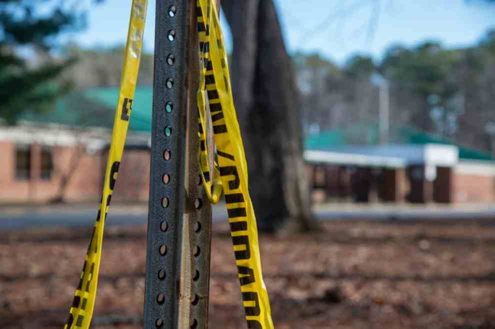 NEWPORT NEWS, VA - JANUARY 07: Police tape hangs from a sign post outside Richneck Elementary School following a shooting on January 7, 2023 in Newport News, Virginia. A 6-year-old student was taken into custody after reportedly shooting a teacher during an altercation in a classroom at Richneck Elementary School on Friday. The teacher, a woman in her 30s, suffered “life-threatening” injuries and remains in critical condition, according to police reports.
