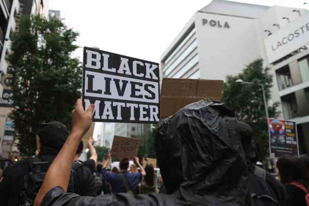 TOKYO, JAPAN - JUNE 14: Protesters hold signs and chant slogans during a Black Lives Matters Peaceful March on June 14, 2020 in Tokyo, Japan. Protesters marched through the Harajuku - Shibuya area calling for the eradication of racism, especially to end discrimination against black people all over the world.
