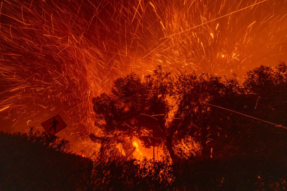 PASADENA, CALIFORNIA - JANUARY 7: Strong winds blow embers from homes burning in the Eaton Fire on January 7, 2025 in Pasadena, California. A powerful Santa Ana wind event has dramatically raised the danger of wind-driven wildfires such as the dangerous and destructive Palisades Fire near Santa Monica. The strong winds also forced President Joe Biden to cancel his plan to travel between Los Angeles and Riverside, California